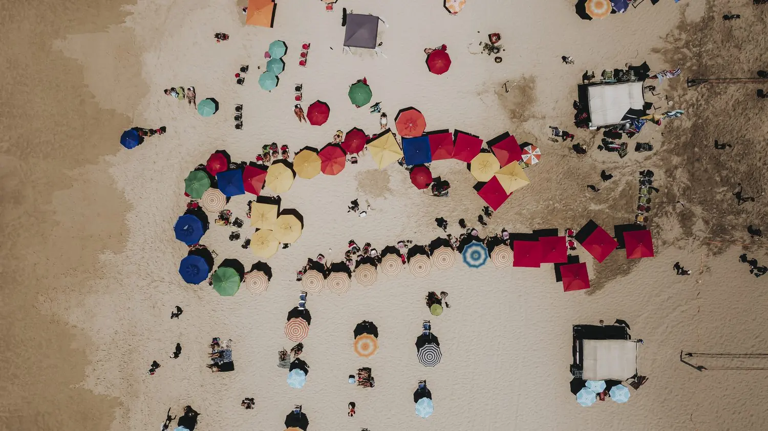 Aerial view of colourful umbrellas on the beach